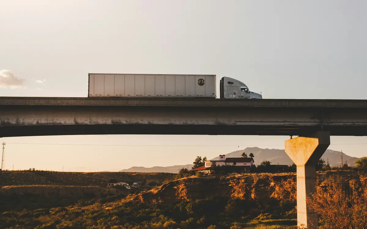 Tratocamión circulando en carretera sobre puente
